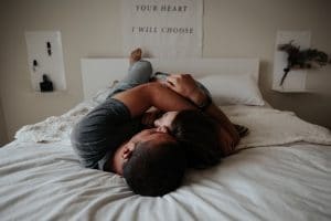 Intimt par der krammer på en seng
